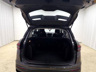 Открытый багажник Geely Coolray 2025: объём и ровная загрузочная платформа, вид на сложенные задние сиденья и внутреннюю отделку багажника в светлой фотозоне.