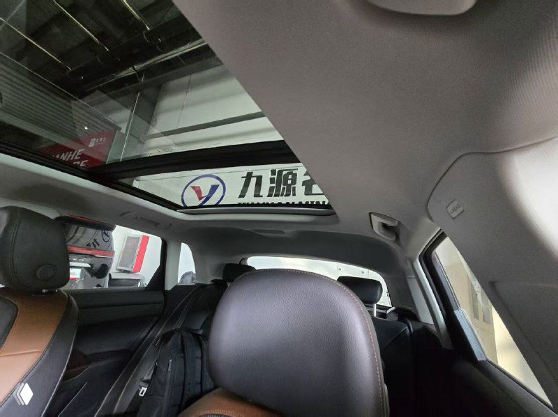 Панорамная крыша/потолок Audi Q3 снята из салона, видно стеклянный люк и обзор назад, демонстрируется опция панорамной крыши в комплектации автомобиля.