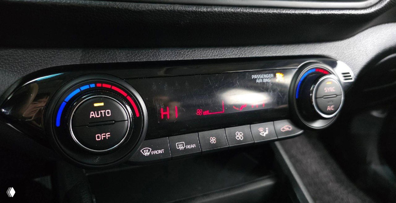 Крупный план блока климат-контроля и регуляторов KIA K3 2021, видны индикаторы, режимы обдува и настройки температуры.