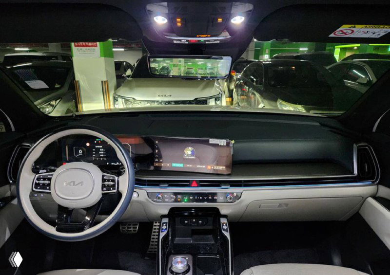 Салон KIA Sorento: панель приборов, мультимедийный экран и рулевое колесо, фото сделано во время осмотра на парковке, состояние приборов видно.