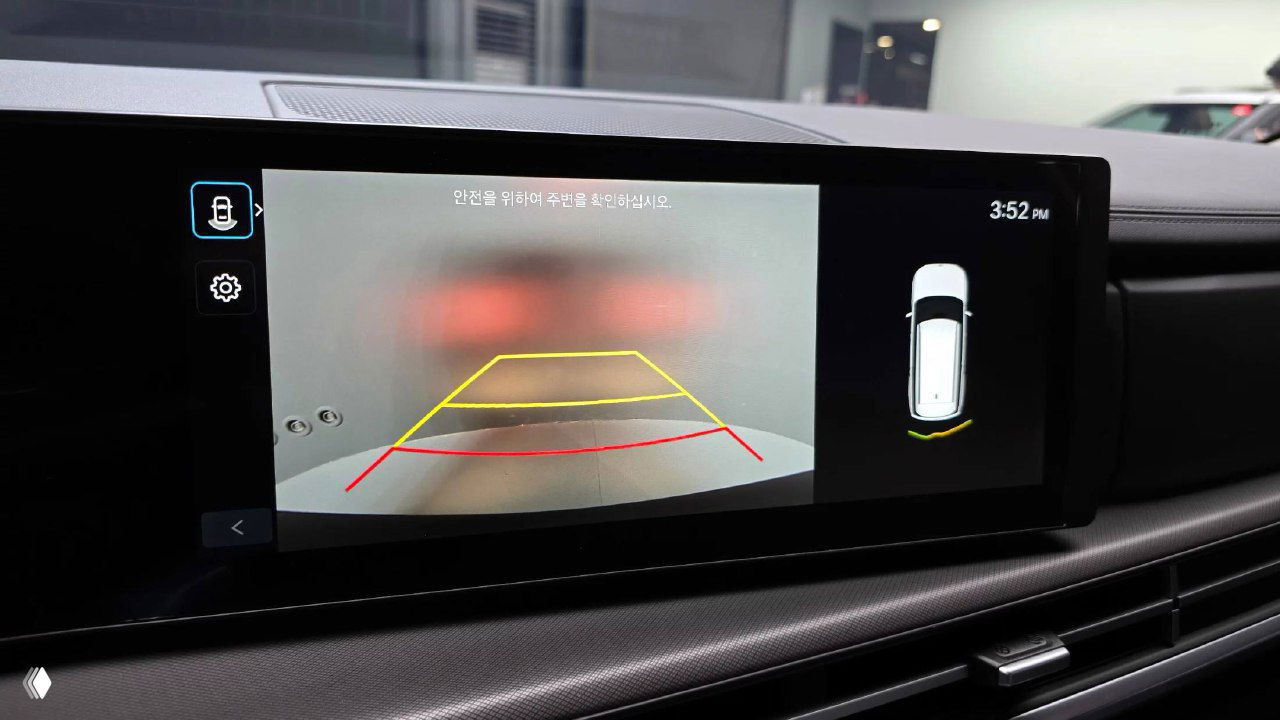 Экран информационно-развлекательной системы Hyundai Santa Fe 2025 с изображением камеры заднего вида и разметки парковки на дисплее автомобиля.
