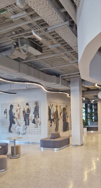 Интерьер выставочного пространства или холла с мозаикой и лавочками — современный оформленный интерьер в здании вокзала, светлые материалы и люди.