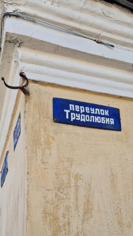Уличный указатель «перевулок Трудолюбия» на углу дома в Затьмачье, виден старый фасад и название колоритного переулка Твери.