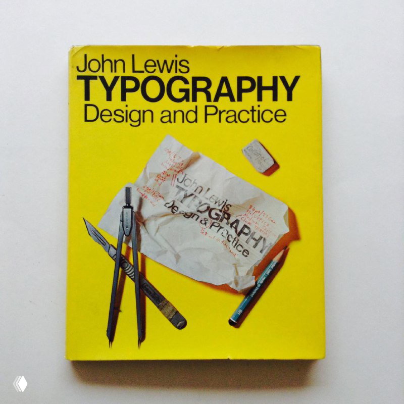 Изображение ярко-жёлтой обложки книги 'Typography' John Lewis с изображением инструментов дизайна и чертежей на переднем плане.