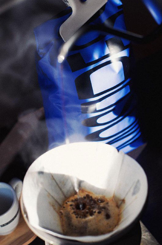 Фильтр-кофе в чашке с паром на фоне упаковки Mospresso; фотография показывает использование продукта, масштаб упаковки и атмосферу подачи кофе.