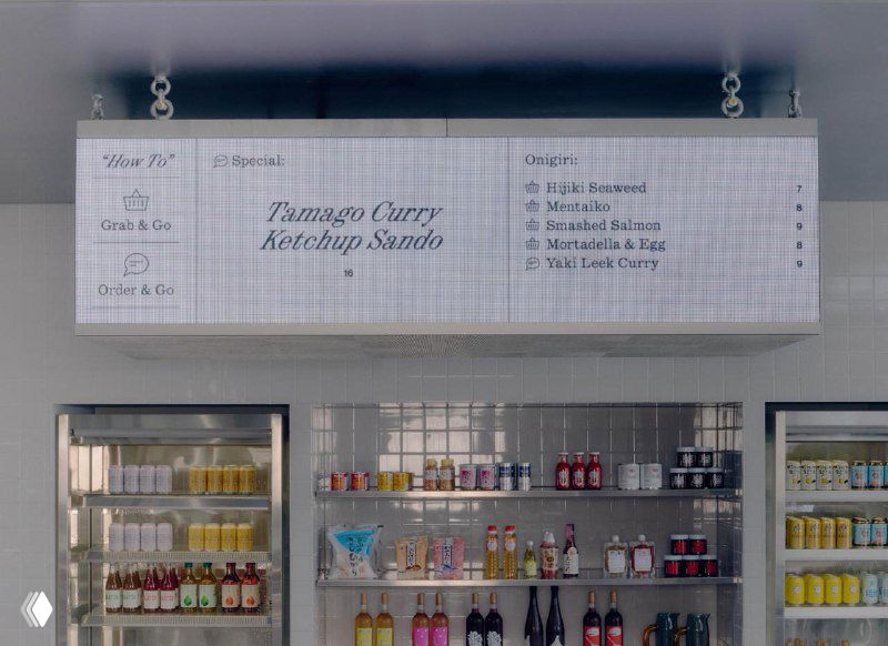 Стеллажи и холодильники с напитками внутри Suupaa: аккуратно расставленные бутылки, ярлыки и сетка элементов айдентики в торговом пространстве.