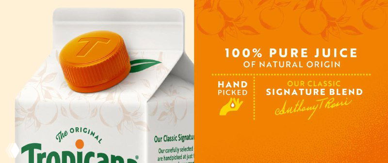 Фрагмент крышки упаковки с тиснённой буквой T и ярко-оранжевым акцентом, подчёркивающий внимание к деталям в упаковочном дизайне Tropicana.