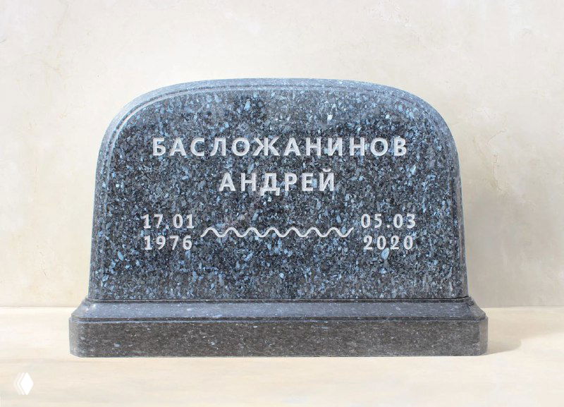 Широкое тёмно-серое надгробие с декоративным рельефом и датами, минималистичный стиль, полированная фактура и нежный студийный свет.