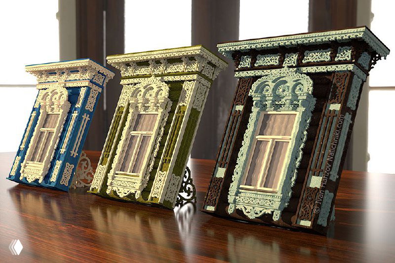 Три миниатюрные собранные модели резных наличников, выставленные на столе, демонстрирующие продукт-конструктор и варианты окраски готовых изделий.