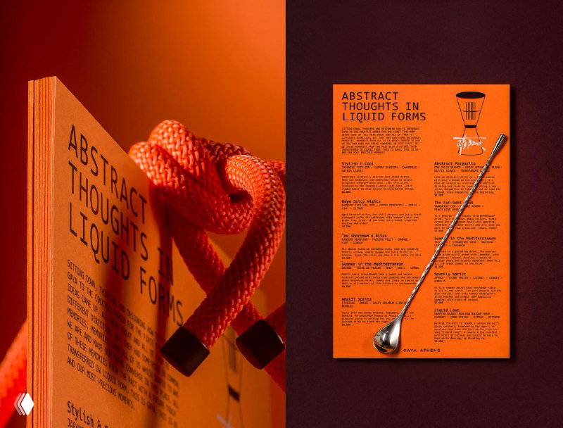 Разворот печатной продукции Gaya Athens: оранжевые листовки и книга с крупным шрифтом, меню и графические элементы демонстрируют типографику и структуру материалов.