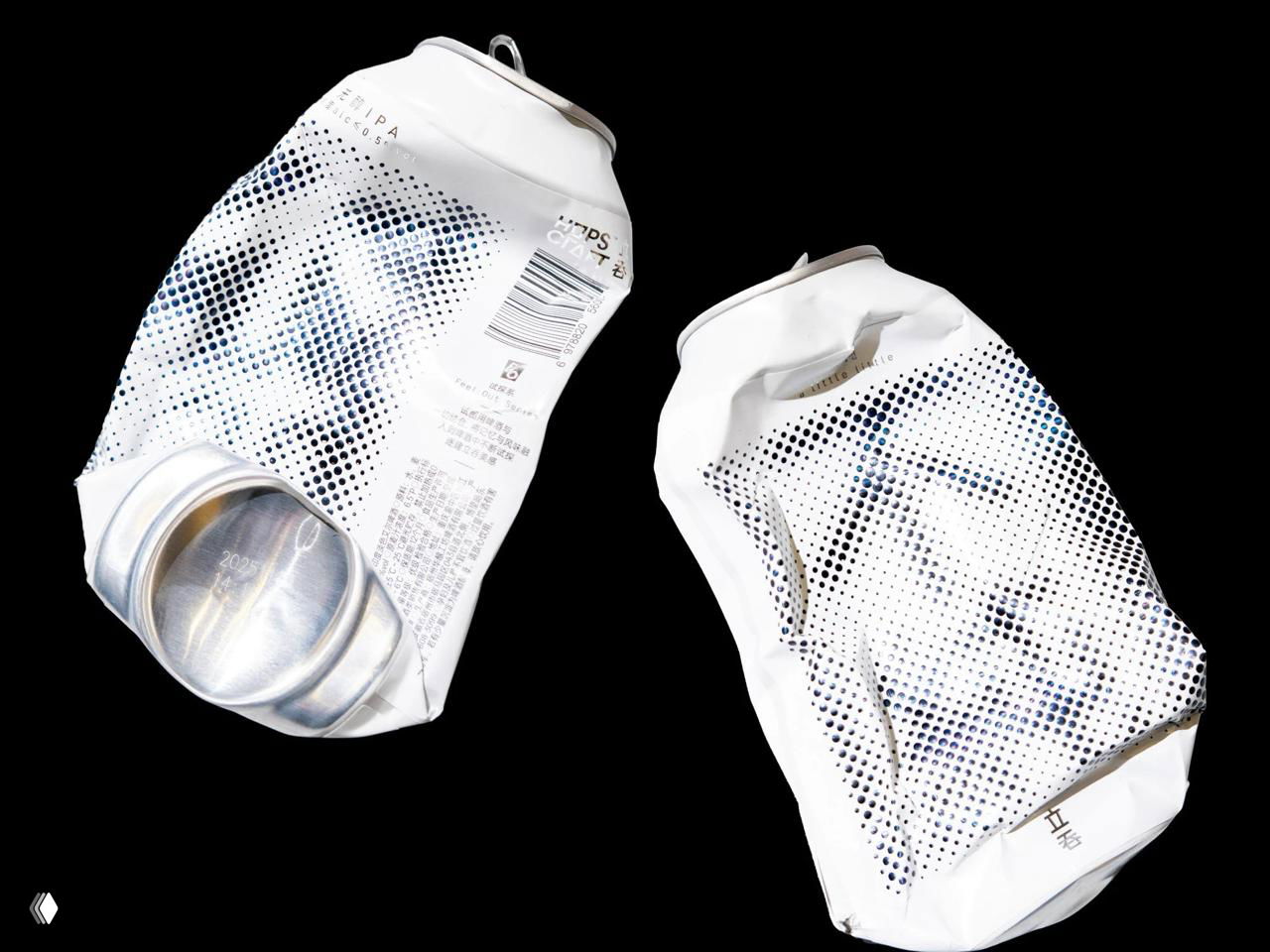 Две смятые банки на чёрном фоне: контраст подчёркивает форму и растровый узор, визуально выделяя дизайнерское решение этикетки