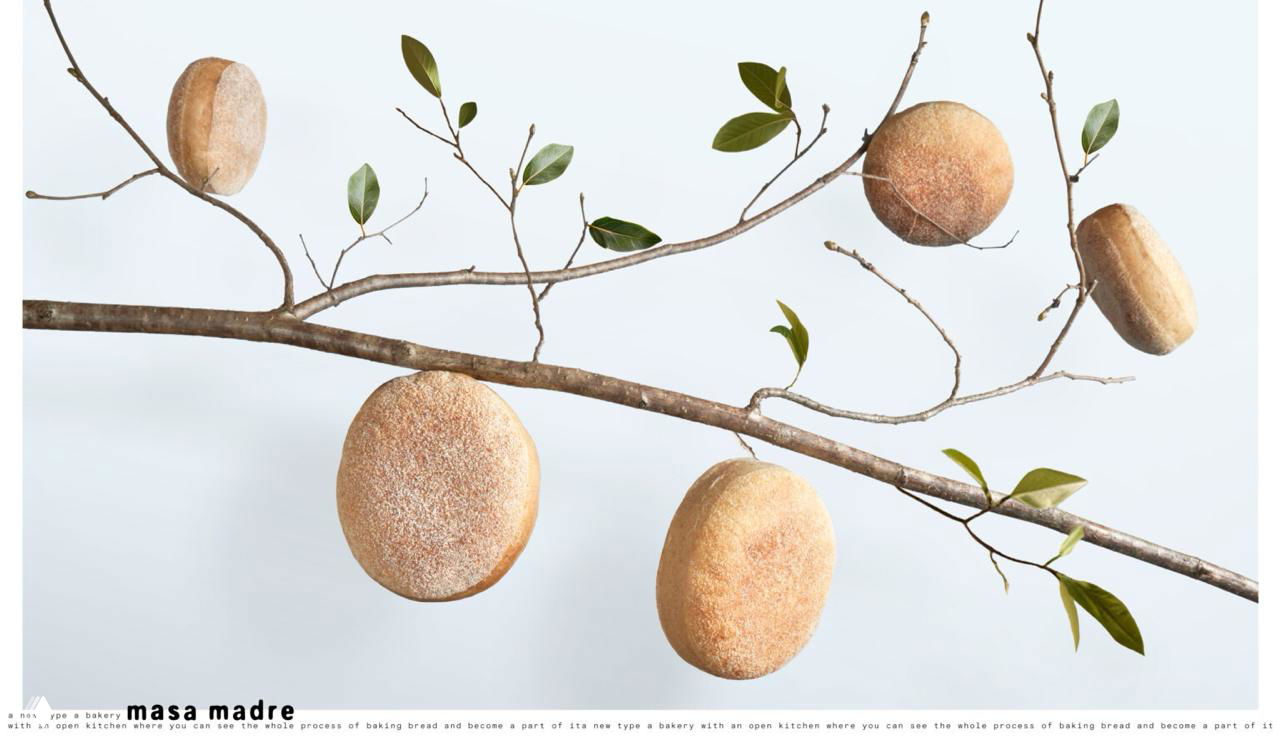 Хлебные булочки, висящие на ветвях с зелёными листьями, композиция подчёркивает идею «выросшего на деревьях» продукта.