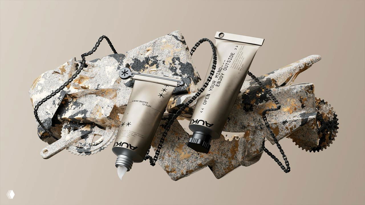 Тюбики AUKI в динамичной композиции на ржавых механических деталях; видна текстура упаковки и небольшие элементы типографики, пасторальный контраст.