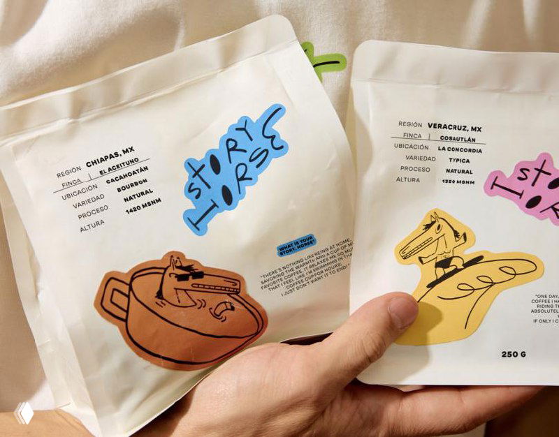 Пачки кофе Story Horse с яркими маркерами и графикой: пакеты лежат раскрытыми, видно информационные наклейки о сорте и обработке зерна.