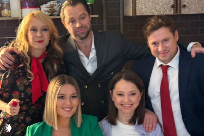 Молодые и зрелые участники актёрского состава «Универ» на общей фотографии — смешанная компания, живая и тёплая сцена.