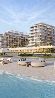 Визуализация курортного комплекса у моря: открытый бассейн у пляжа, шезлонги и круглые лежаки, видовые террасы и многоквартирные корпуса.