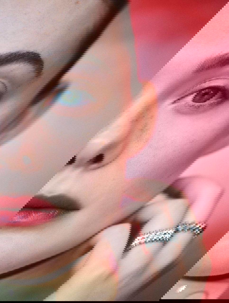 Крупный план лица Эль Фаннинг с естественным макияжем и аксессуарами — акцент на глазах, губах и украшениях.