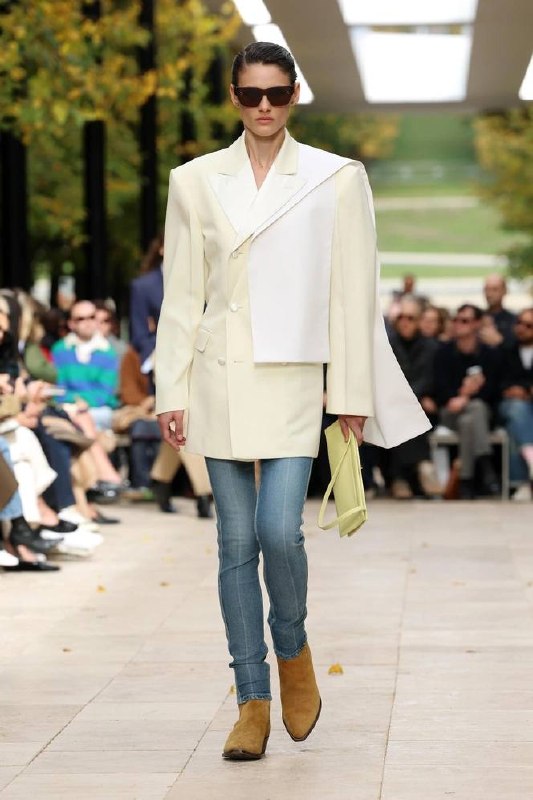 Классический кремовый жакет Zimmermann в образе на подиуме: сочетание белого и сливочного, джинсовая деталь и аккуратные коричневые ботинки.