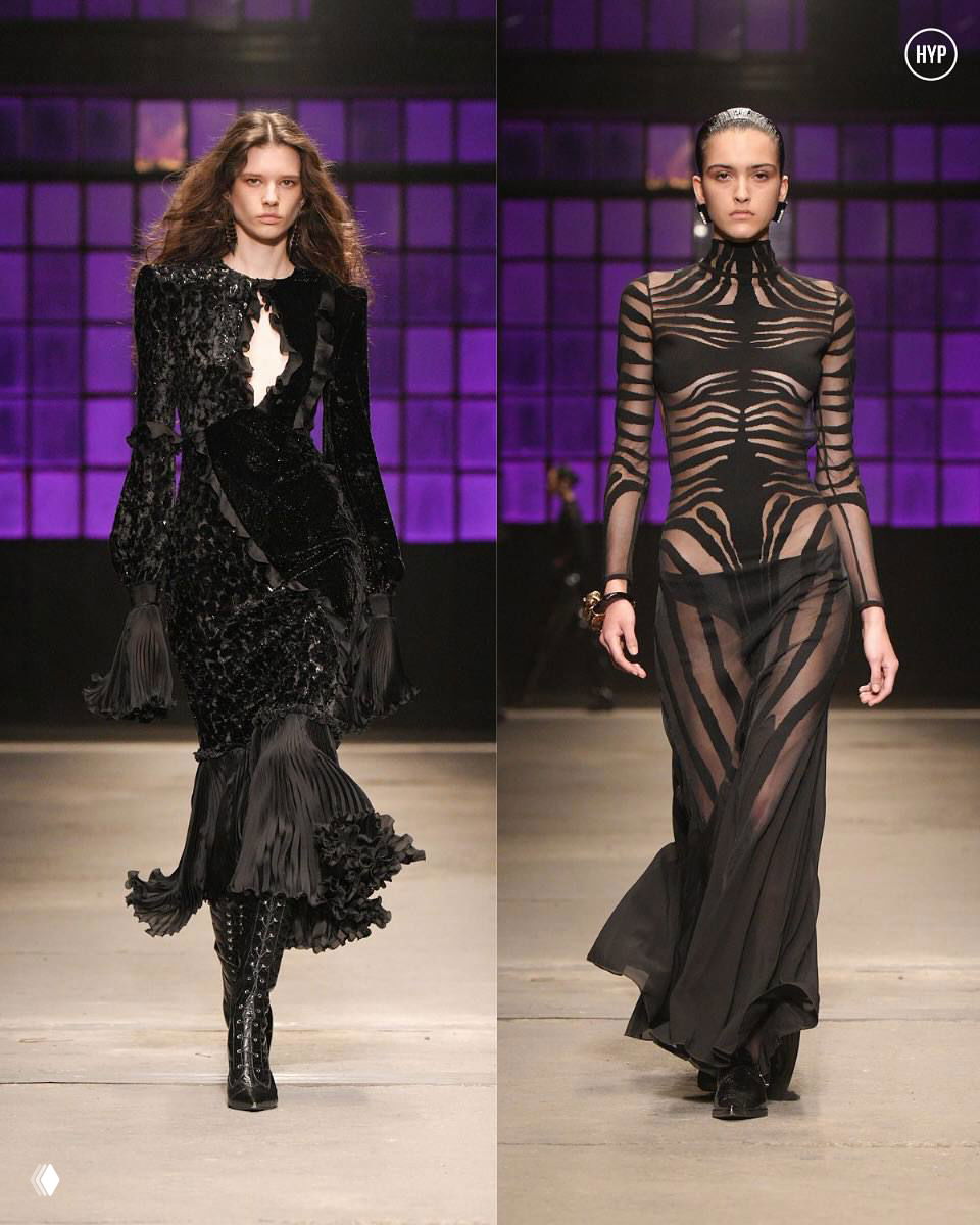 Две модели в длинных чёрных силуэтах Roberto Cavalli: фактурное платье и полупрозрачный костюм с графическим рисунком на подиуме.