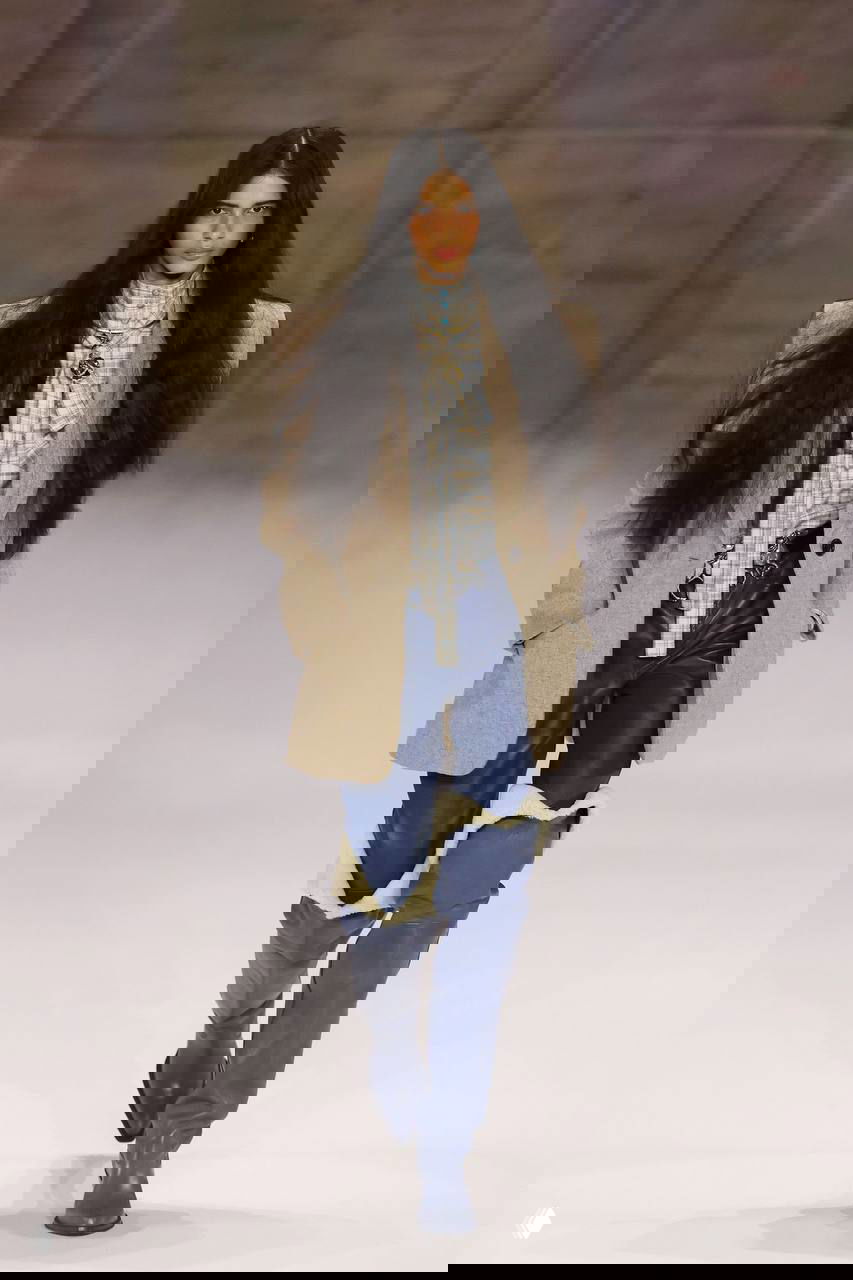 Длинные тёмные волосы, объёмный пиджак и сапоги с меховой отделкой в нежно-деревенской палитре — загородный шарм в городской подаче.