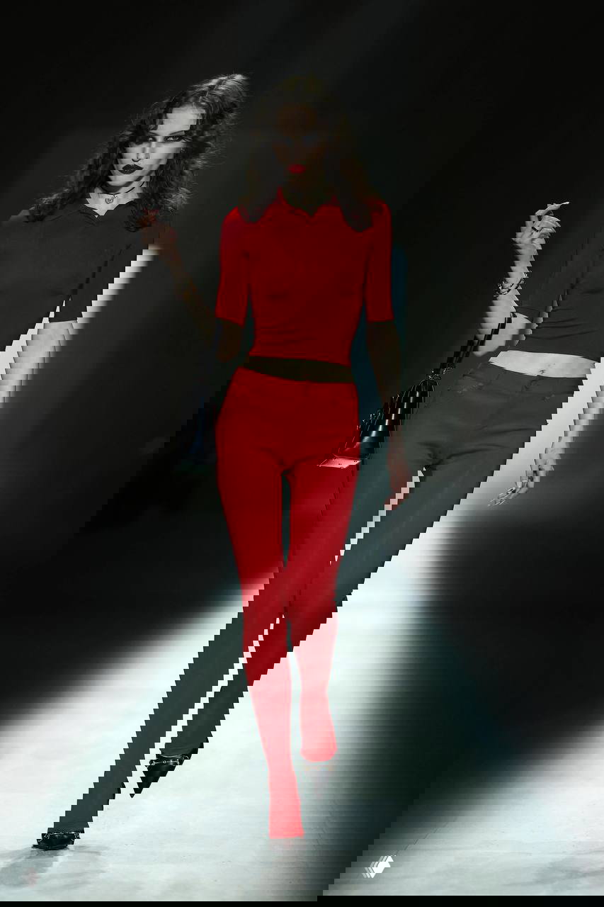 Показ с ярким красным образом: приталенный топ и узкие брюки насыщенного цвета, образ ради воздействия и «порции дофамина» в гардеробе.