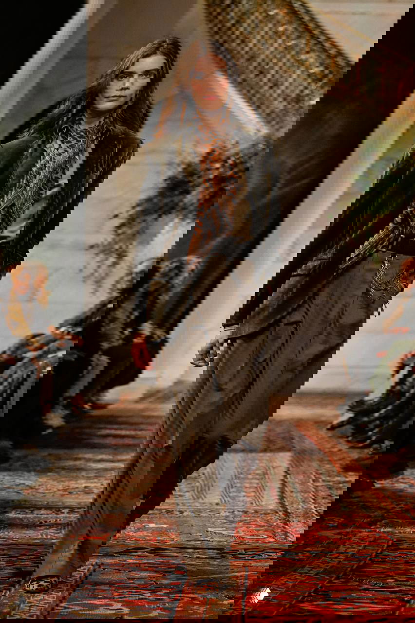 Модель в оливковом пиджаке и широких брюках, леопардовый шарф и тонкая цепочка на поясе — сочетание классики и анималистичных мотивов.