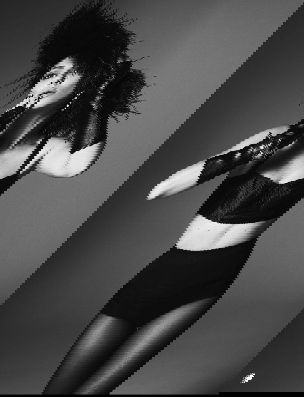 Динамичный студийный портрет: большая шляпа с перьями, бра и перчатки, образ в духе ретро‑моды, монохромная гамма.