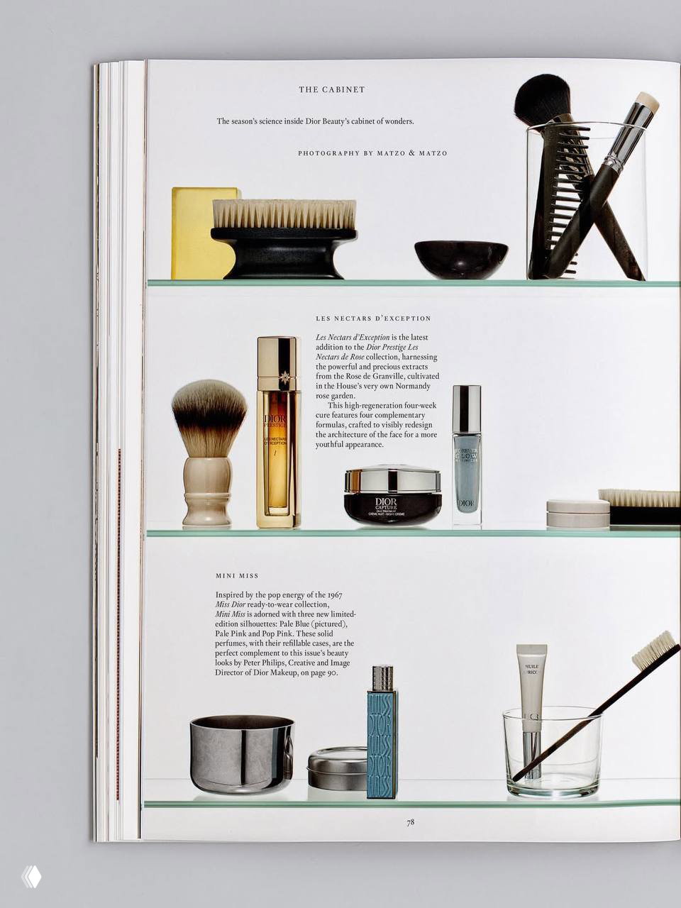 Разворот журнала с косметическими средствами Dior: флаконы, кисти и баночки на стеклянных полках — демонстрация бьюти-рубрики из A New Look.