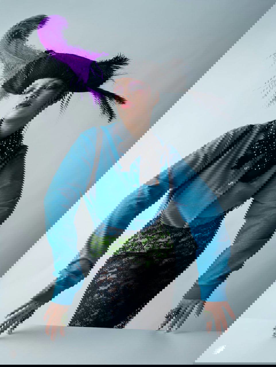 Рианна в историческом зале под люстрой, белый романтический костюм с кружевами и мечтательная поза — визуально насыщенная стилизация Тима Уокера.