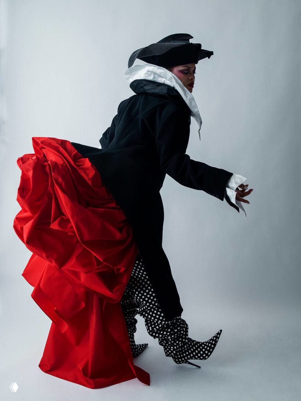 Темный кадр с Рианной в кружевном образе на бархатном диване, атмосферная игра света и тени, напоминающая кинематографические фотосессии Вима Вендерса.