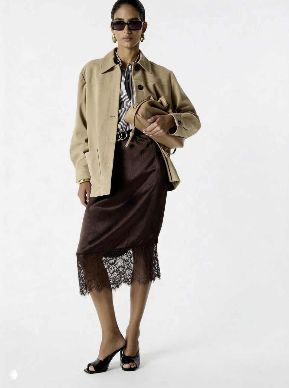 Модель в бежево-шоколадных тонах: жакет или куртка, тёмная юбка с кружевной отделкой внизу — контраст гладкой ткани и кружева в луке Liu•Jo.