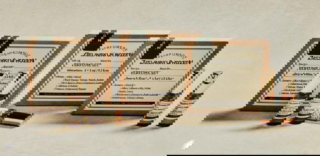 Мини‑флаконы и картонные коробки парфюмерных сетов Zielinski & Rozen на столе; винтажная упаковка, идеальна для подарка и тестирования ароматов.
