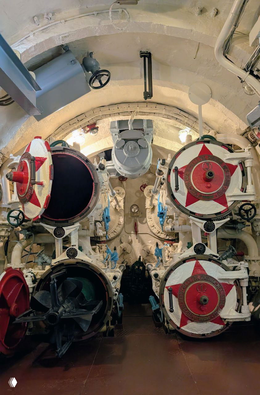 Торпедные аппараты и механизмы внутри подлодки С-56: шесть круговых люков, краны и механическая обстановка боевого отсека.