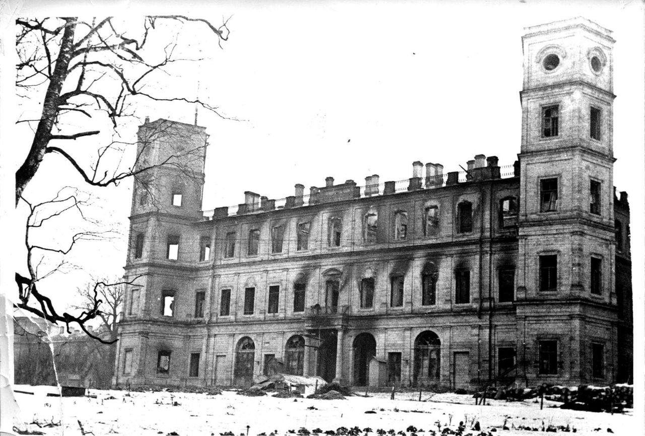 Фасад дворца при искусственном освещении на фоне сумерек: светлые стены, ряд окон и ощущение внушительной архитектурной массы исторического здания.