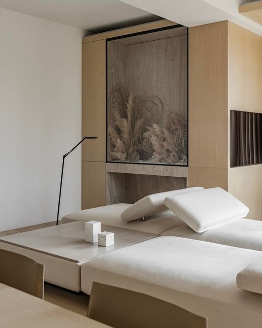 Минималистичная спальня в светлых бежевых тонах с низкой мебелью и нишами, строгая текстура и спокойная палитра. Представлен в подборке ADDAWARDS 2025.