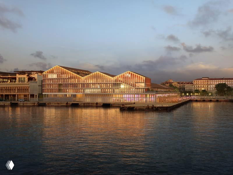 Вечерний вид обновлённого фасада порта в Марселе: скатные крыши павильонов и отражение зданий в спокойной прибрежной воде