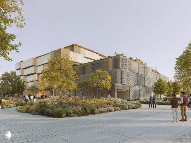 Панорамный вид территории библиотеки в Жешуве: прогулочные зоны, деревья, террасы здания и люди на благоустройстве.