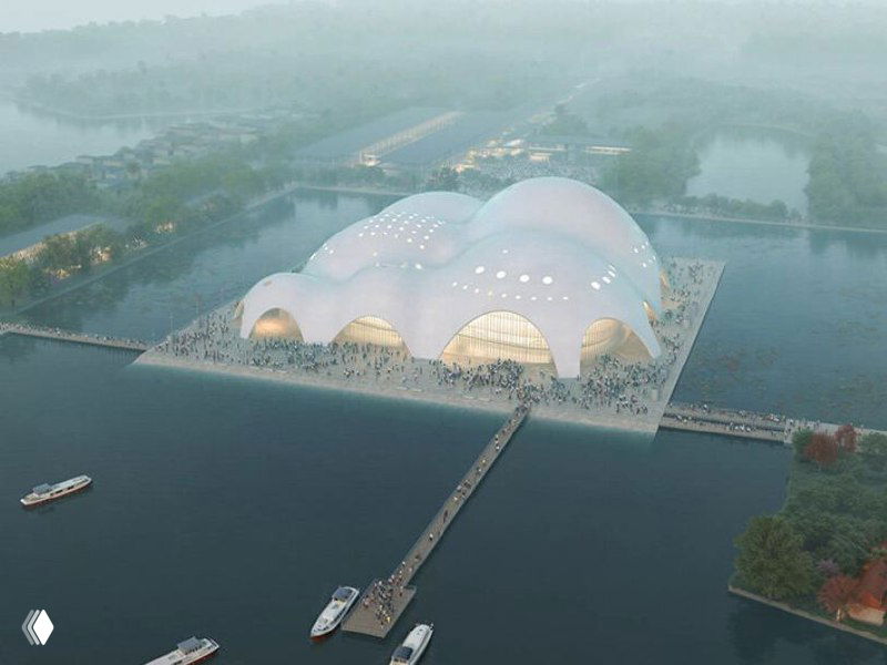 Аэровизуализация проекта «Остров музыки»: ряд волнообразных бетонных оболочек на платформе посреди озера и пешеходный мост к главному входу.