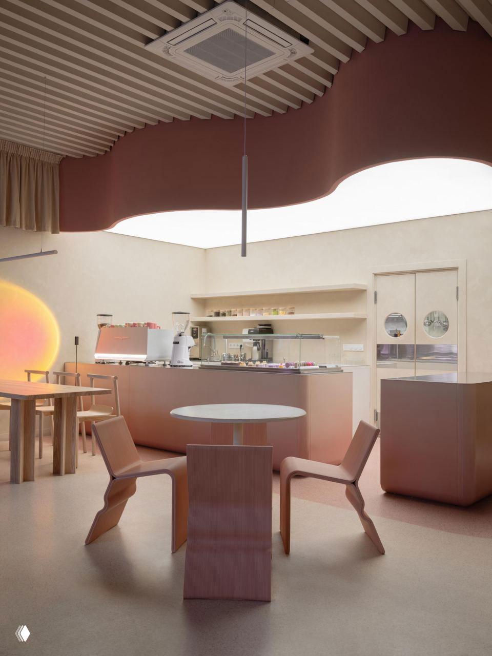 Барная зона с розово-бежевым прилавком, кофейным оборудованием и зонированным потолком; минималистичный дизайнерский приём в интерьере.
