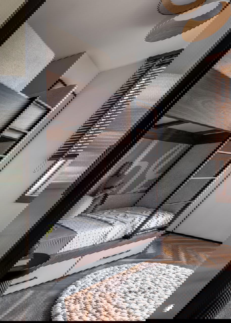 Детская с двухъярусной кроватью из тёмного дерева, мягким ковриком-пуфом на полу и большим окном — функциональное пространство для двоих детей в компактной планировке.