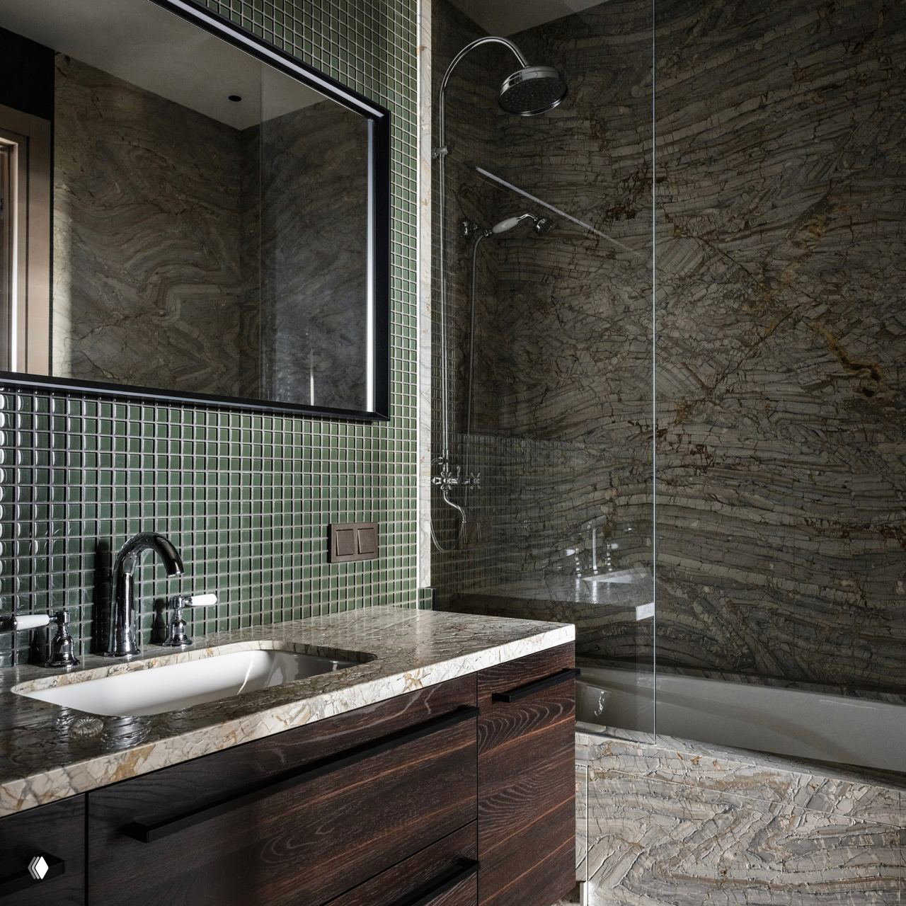 Тёмная ванная с мраморной столешницей и врезной раковиной, зелёная мозаичная плитка фартука и стеклянная перегородка душевой зоны