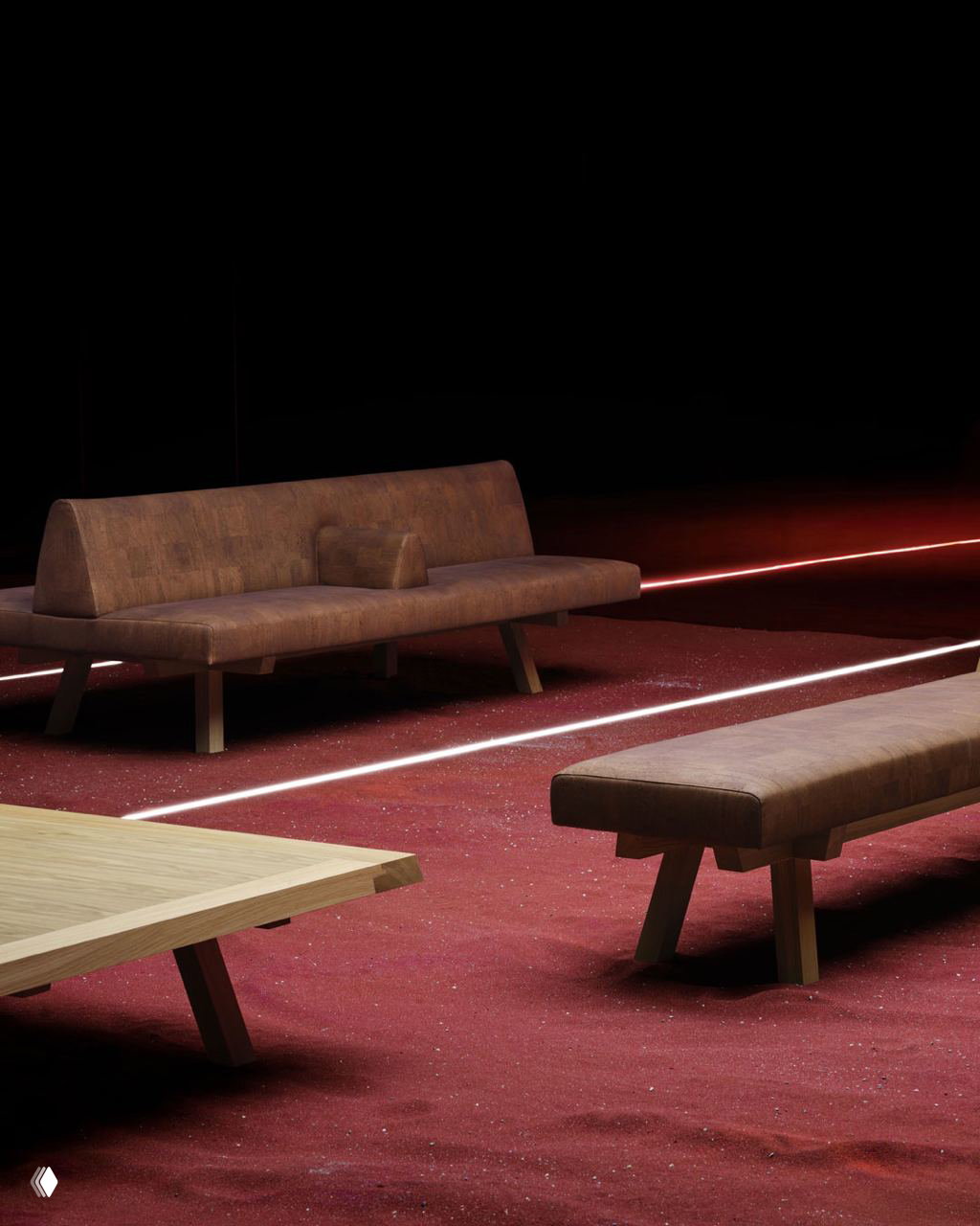 Диван и скамья из коллекции MTM с обивкой из пробковой кожи на красноватом покрытии выставочной площадки в минималистичной постановке.