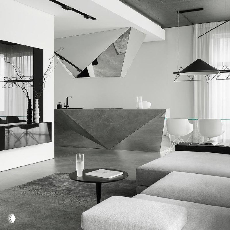 Монохромная интерьерная сцена в белых и серых тонах: диван, журнальный столик и декоративные элементы в строгой графике.