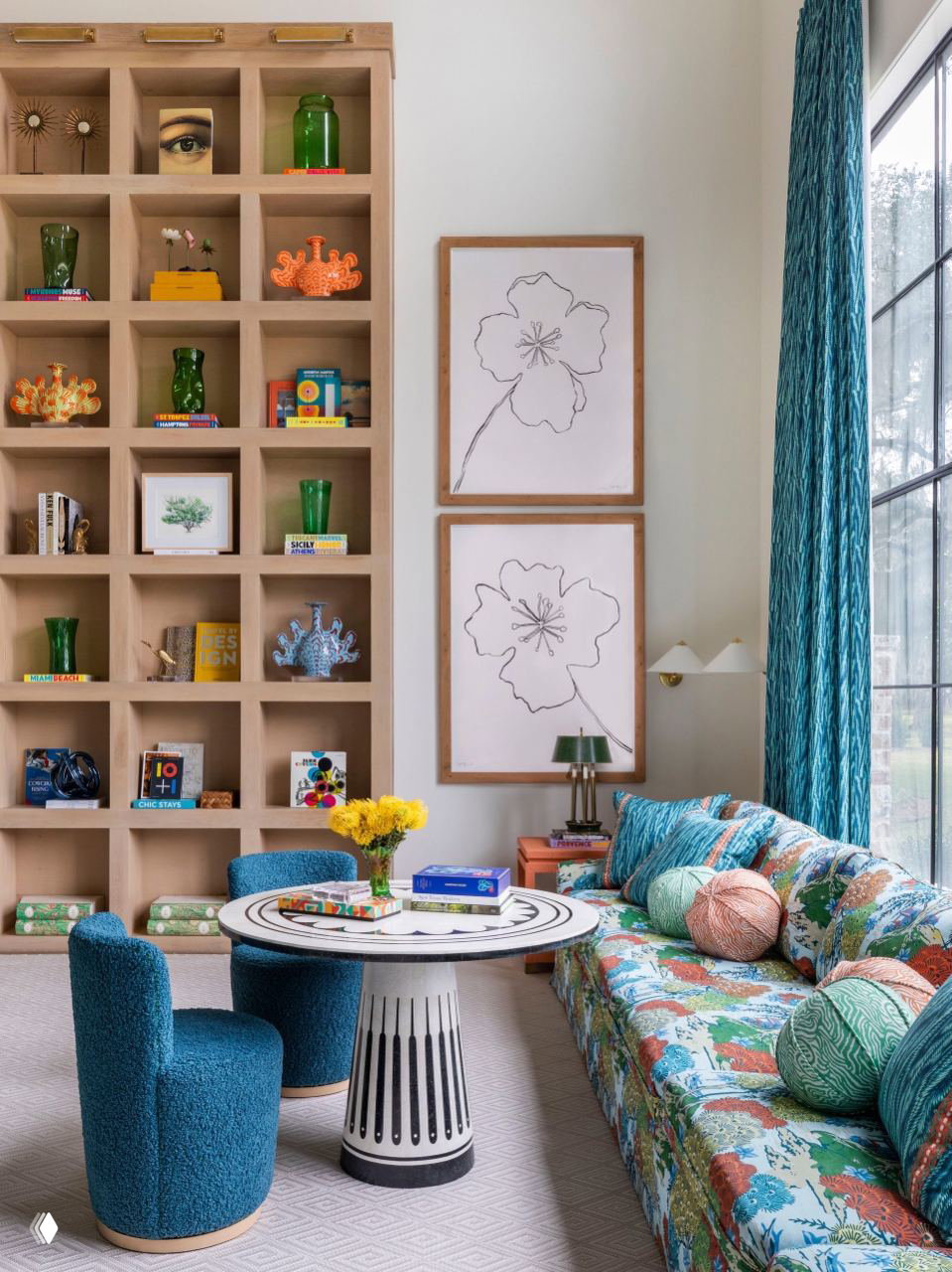 Декоративная стеллажная система с квадратными нишами, в которых собраны книги, стеклянные вазы и мелкие предметы коллекции, рядом — окно в пол.