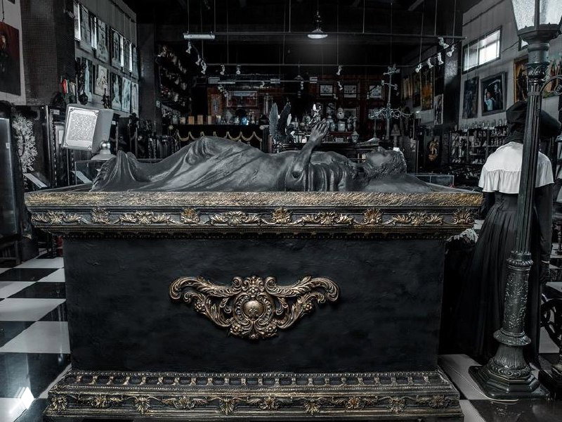 Ритуальный саркофаг и лежащая фигура в центральной экспозиции музея, декоративные орнаменты и музейное освещение создают атмосферу мемориала.