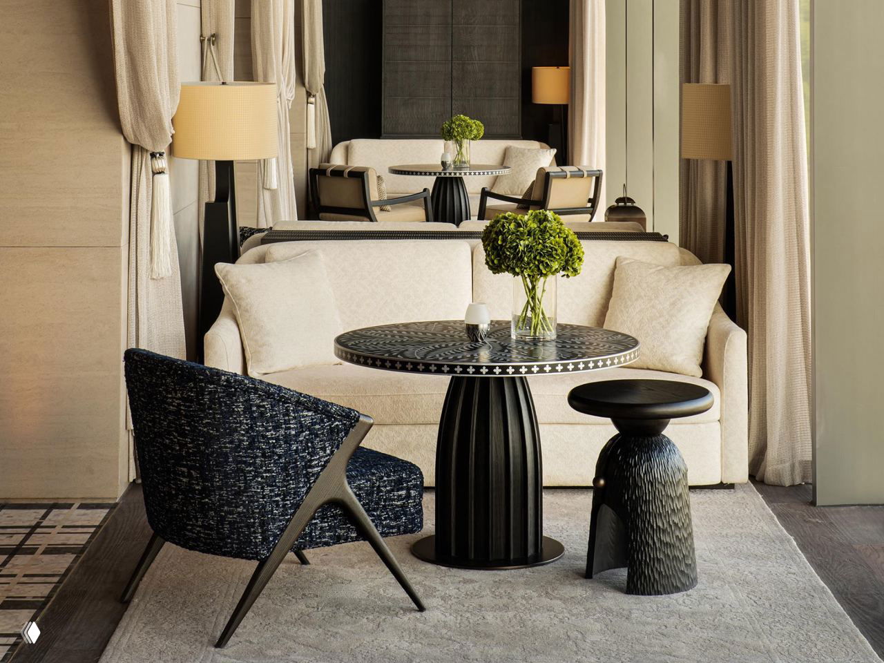 Уютная гостиная зона номера: текстурная мебель, низкий столик и мягкая палитра материалов, подчёркивающие локальный колорит и комфортные зоны отдыха для гостей.