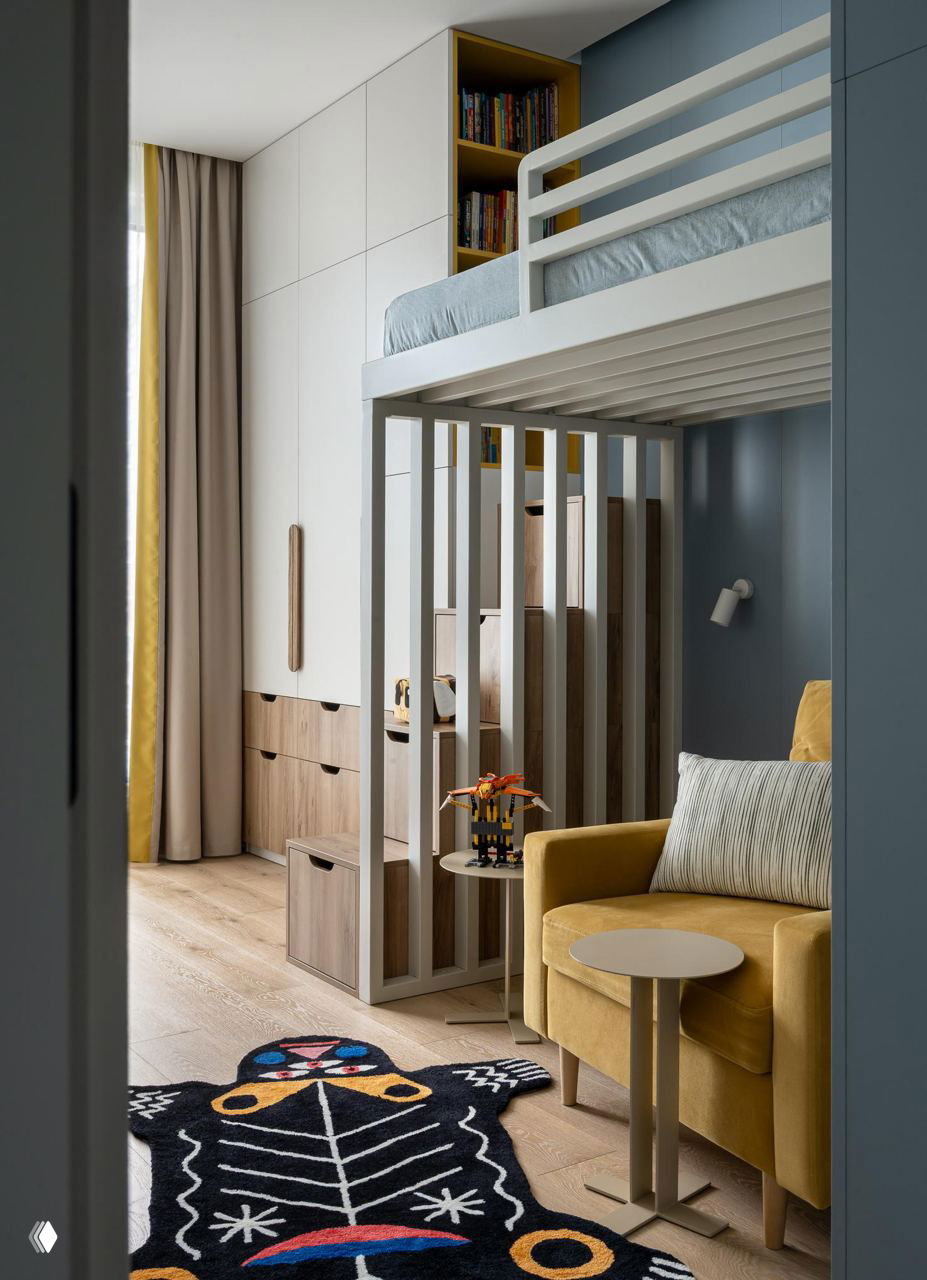 Детская с двухъярусной кроватью, жёлтым мягким креслом и декоративным ковром, организованное пространство для игр и отдыха.