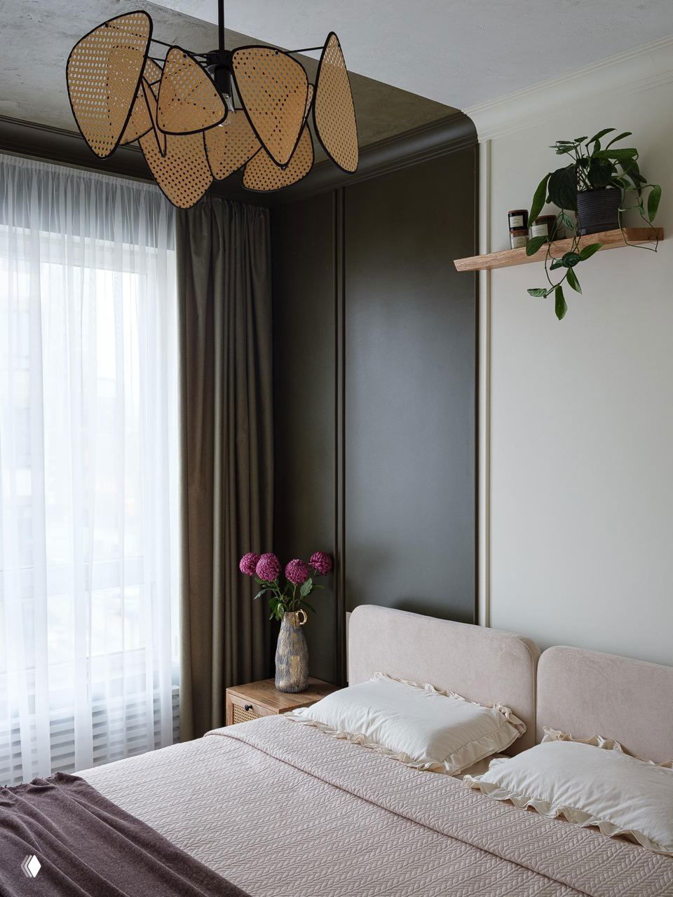 Спальня с нежным текстилем и болотной панелью за изголовьем: спокойная цветовая гамма сочетается с деревянными тумбочками и растением.