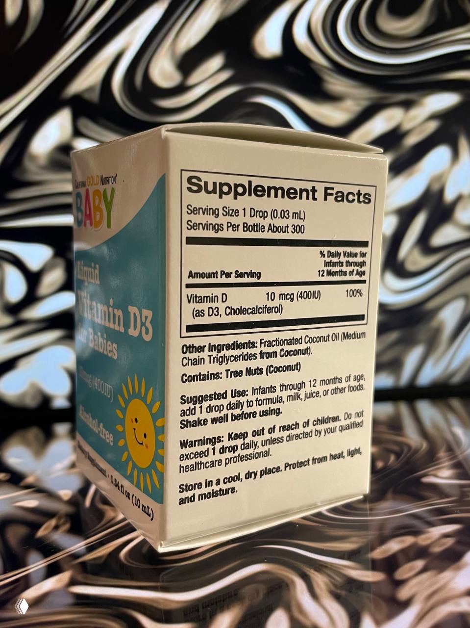 Боковая панель упаковки с таблицей Supplement Facts: указана порция 1 капля = 10 мкг (400 IU), состав, предупреждения и рекомендации.