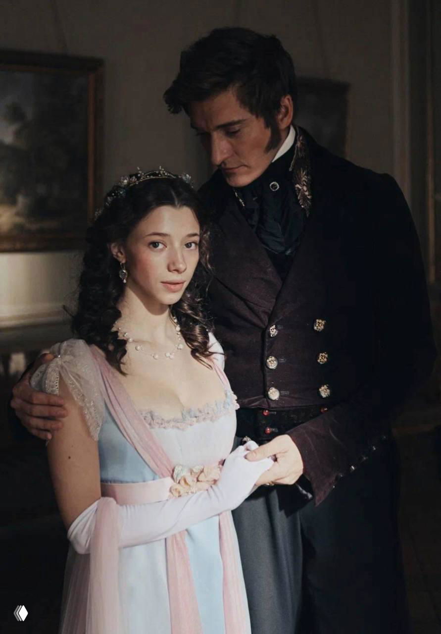 Полина Гухман и партнёр по сцене в полуфигурном кадре: характерные костюмы XIX века и интимная театральная постановка сцены.